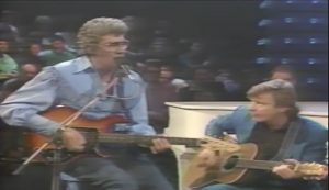 Watch Carl Perkins, George Harrison, and Eric Clapton’s Legendary Medley In 1985