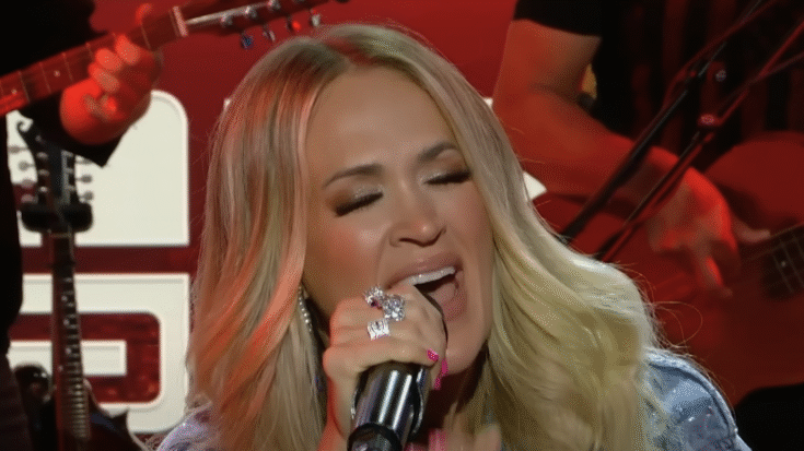 Carrie Underwood passionately singing on stage during her performance of Ozzy Osbourne’s “Mama, I’m Coming Home” on The Howard Stern Show.