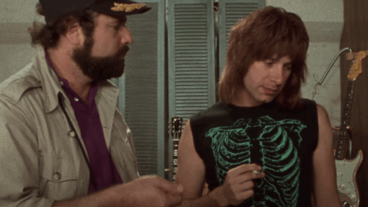 Rob Reiner as filmmaker Marty Di Bergi talks with Nigel Tufnel (Christopher Guest) in a scene from This Is Spinal Tap, showcasing the mockumentary’s signature dry humor and iconic rock parody.