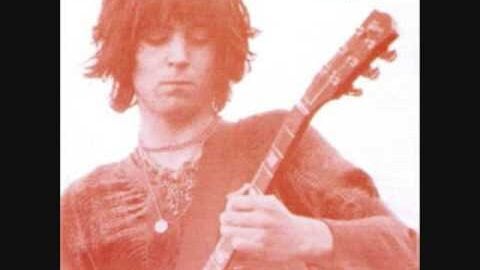 Terry Reid on the cover of his 1969 self-titled album, playing guitar in a red-tinted photograph.