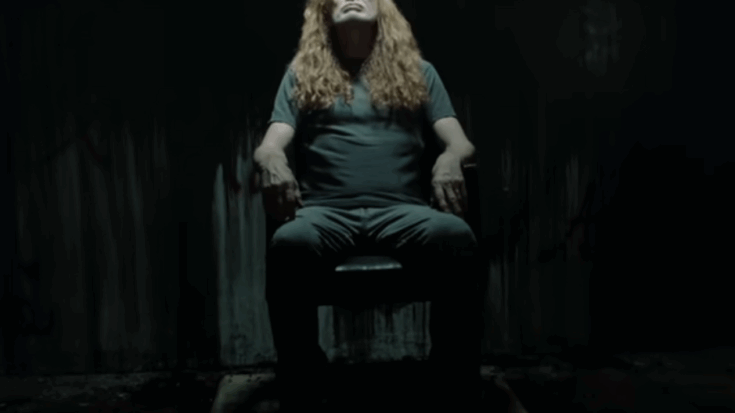 Dave Mustaine sitting in a dark room in the music video for Megadeth’s new single “Tipping Point.”