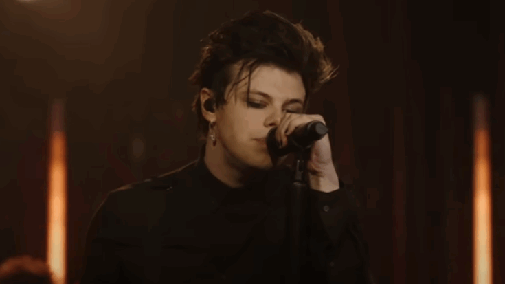 Yungblud performs passionately on stage, singing into a microphone during his cover of “Linger” by The Cranberries.