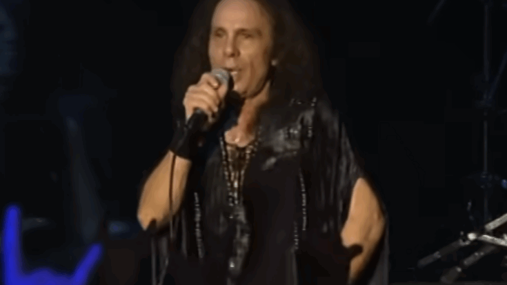 Ronnie James Dio performing on stage, holding a microphone during a live concert.