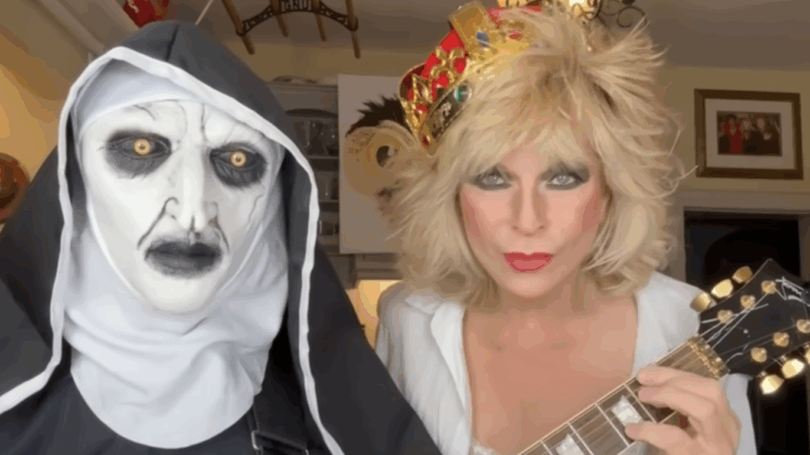 Robert Fripp and Toyah Willcox in their Halloween-themed costumes during their “Highway to Hell” Sunday Lunch performance, with Fripp dressed as a sinister nun and Toyah wearing a crown while holding a guitar.