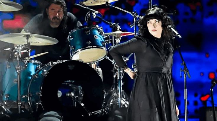 Violet Grohl performing onstage during the Fire Aid benefit concert, singing in front of her father Dave Grohl on drums alongside the surviving members of Nirvana.